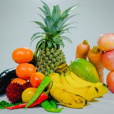 A colorful display of fresh tropical fruits and vegetables for healthy eating.